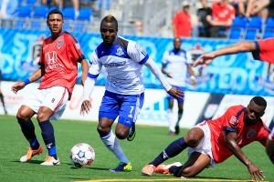 FC Edmonton's Horace James, centre, skips by Indy's Kleberson, left. PHOTO: FC EDMONTON/TONY LEWIS