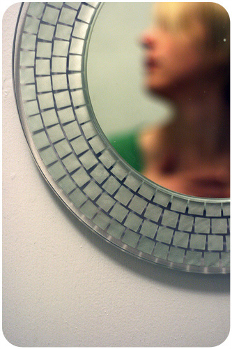 Woman's face in mirror