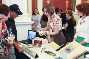 Abigail Weaver of CALM demonstrates her work with miniature books from the Library collections. Photo by Amanda Reynolds. 