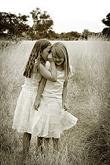 Girls whispering in ear