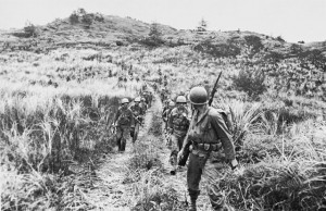 Men of Company B, 305th RCT, moving out from high ground on Guam. (US Army Center of Military History)