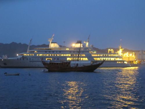 A dhow and a yacht in the harbor