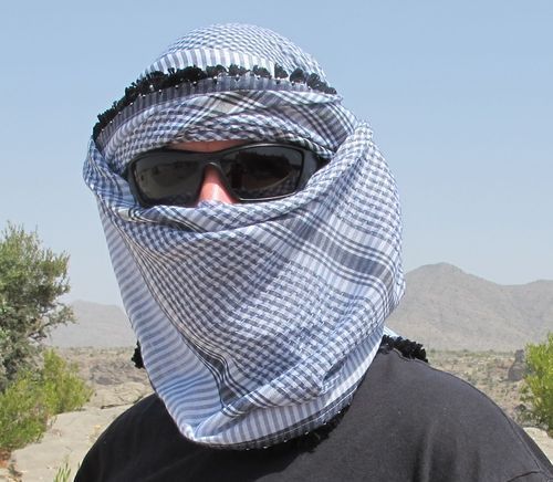 The Omani head scarf, extreme style! You'd only wear it across your face like this to protect against wind and sand. Or if you're an international man of mystery....