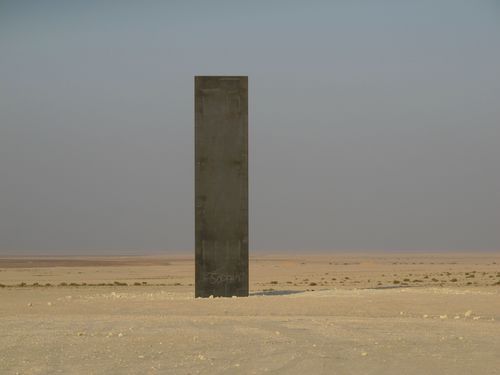 One of the four steel plates standing in a line in the Qatari desert