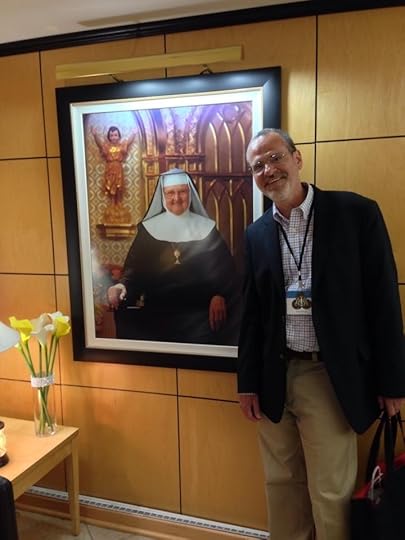 Catholic speaker and author Gary Zimak posing next to a portrait of Mother Angelica at EWTN