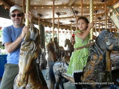 riders on Griffith Park Merry-Go-Round in Los Angeles, California