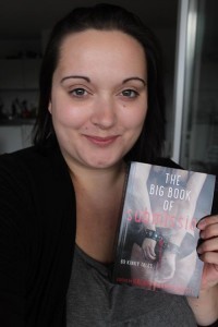 Laila-after-the-Dentist holding copy of The Big Book of Submission.