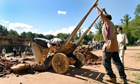 Workers carry stones on the construction site