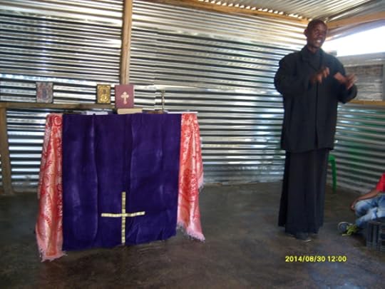 Father Markos speaking to the congregation at Madidi.