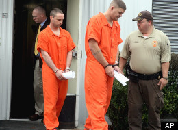 Michael Burnett, Christopher Salmon FILE - In this Dec. 12, 2011 file photo, U.S. Army Pfc. Michael Burnett, 26, right, and Pvt. Christopher Salmon, 25 are led away in handcuffs after appearing before a magistrate judge at the Long County Sheriffs Office Monday, in Ludowici, Ga. Prosecutors said Monday, Aug. 27, 2012 that a murder case against four soldiers in Georgia has revealed they formed an anarchist militia within the U.S. military with plans to overthrow the federal government. Prosecutors in rural Long County, near Fort Stewart, said the militia group spent at least $87,000 buying guns and bomb components and was serious enough to kill two people, former soldier Michael Roark and his 17-year-old girlfriend, Tiffany York, by shooting them in the woods last December in order to keep its plans secret. (AP Photo/Lewis Levine, File)