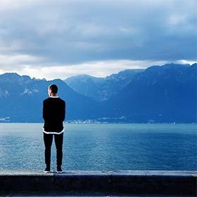 Make Good Decisions - Man Standing in Front of Lake
