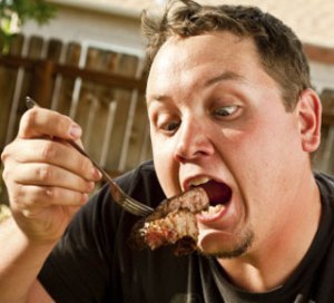 man eating meat