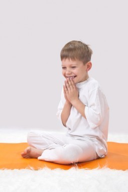 Children's yoga. The little boy does exercise.