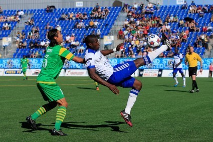 Kareem Moses, right, clears a ball away from the path of Tampa Bay's Willie Hunt. FC EDMONTON/TONY LEWIS
