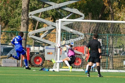 Tomi Ameobi gets the shot through the hands of Cosmos keeper Jimmy Maurer for the equalizer. PHOTO: TONY LEWIS/FC EDMONTON