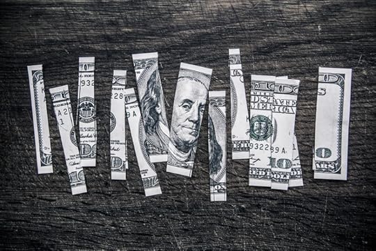 Money cut in pieces, by Tax Credits. CC-BY-2.0 via Flickr.