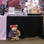 Tristan the Teddy Bear hanging at his Artist Alley Table