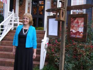 At the gala beside signs that resemble a colonial tavern.