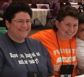 2 women at a banquet wearing T-shirts as described above