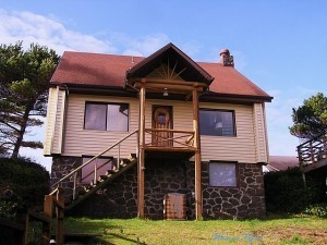 2-story house with log stairs and railing