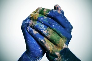 a world map in man hands forming a globe (Earth map furnished by