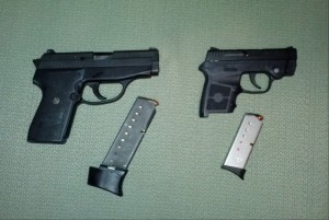 SigSauer P239 and Smith & Wesson .380 with accompanying magazines. Image by Piper Bayard.