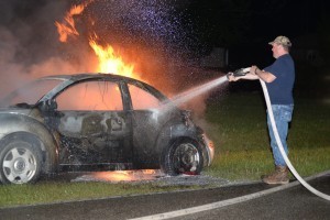 Man hoses down burning VW bug