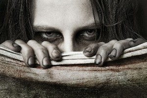 girl zombie behind book close up