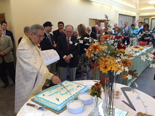 Here, the priest carves the sign of the cross into the surface of the cake.