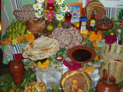 Traditional grave-side offerings--cigarettes, decorated bread, fruit, beer and mescal--in Oaxaca. Phot credit: T. Gething