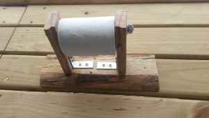 Yes, that is a DIY toilet paper dispenser. Though crude, it cost nothing to make and complimented our theme.