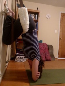 photo of yoga pose Virasana, hanging from yoga swing.