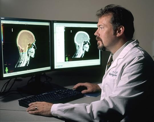 Doctor review brain images by Rhoda Baer. Public domain via Wikimedia Commons