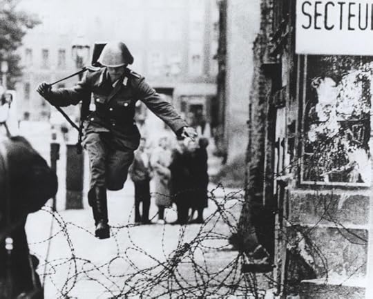 Conrad Schumann escaping across the barbed wire (Image from flickr.com/The Central Intelligence Agency)