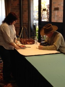 Craig Johnson signing a book for a fan