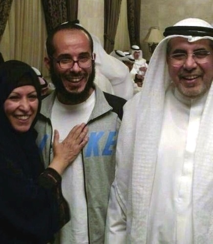 In this photo released by the al-Odah family, Fawzi al-Odah is shown with an unidentified relative on the left and his father Khalid on the right on his arrival in Kuwait on November 6, 2014.