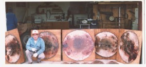 Grandpa with his prized beaver hides, stretched neatly onto various sized boards.