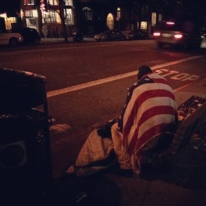homeless man in flag