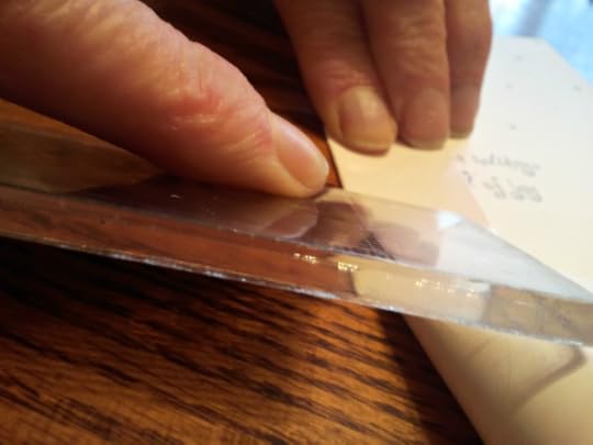 Flatten folded edge of Christmas card