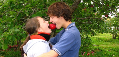 Young lovers eating an apple