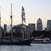 A tall ship passes Canary Wharf