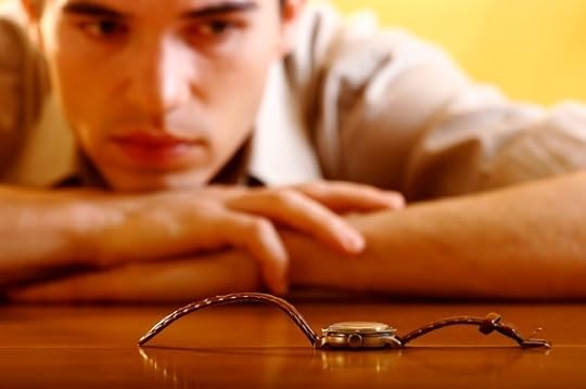 A Man Looking at a Watch on a Table - Photo courtesy of ©iStockphoto.com/Cimmerian, Image #1205738