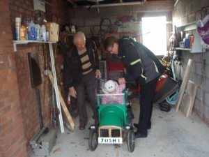 Dad and I load my daughter into the car he made.