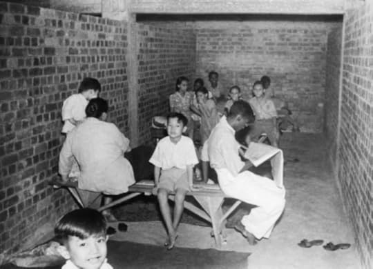 Civilians in Singapore in an air raid shelter, December 1941 (image via wikicommons)