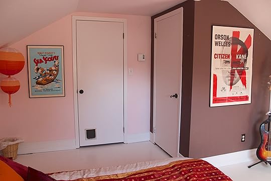 The wall around the walk-in closet is now an accent wall in a rich chocolate brown. The baseboards are wider, and the art on the walls is better proportioned to fit the space.