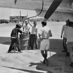 Hand fueling an airplane, location unknown