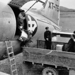 Unloading cargo from a C-46, late 1940s