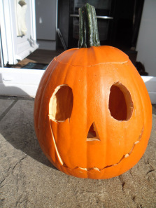 Our homegrown pumpkin all carved up. The scar was a mistake, but I think it makes him look pretty bad-ass!