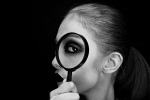 woman looking thru mag glass black and white2