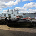 The Olympic warship and the Thames tug